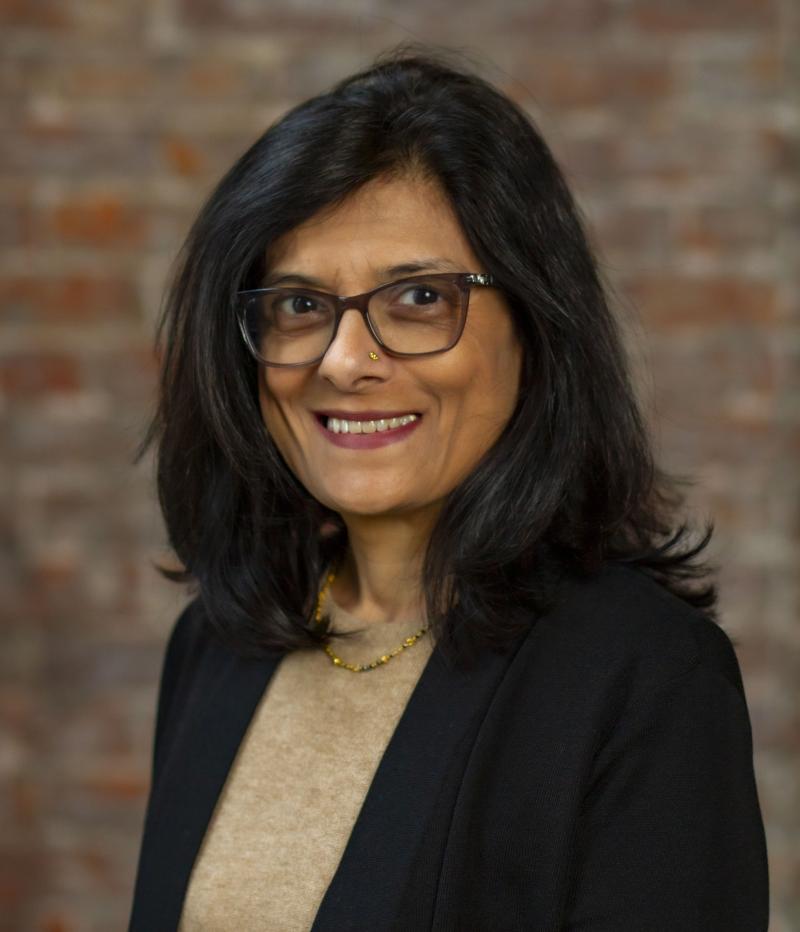 woman in glasses smiling at camera