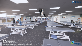 Large open room with many treatment tables lined up in rows.